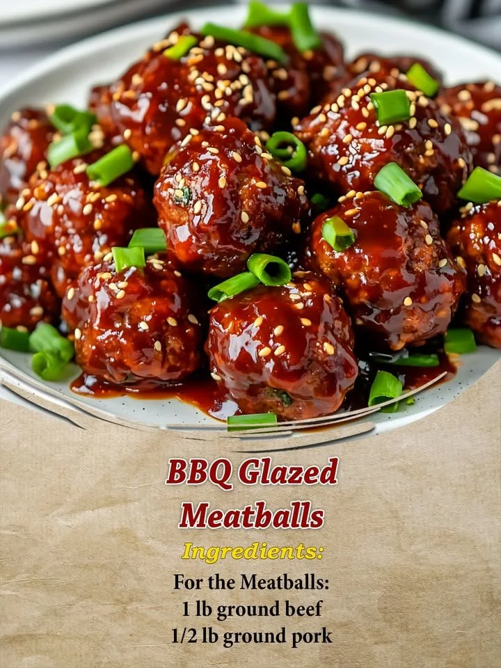 Delicious BBQ glazed meatballs served in a bowl, garnished with fresh herbs.
