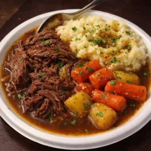 Delicious beef pot roast with potatoes and carrots served on a plate