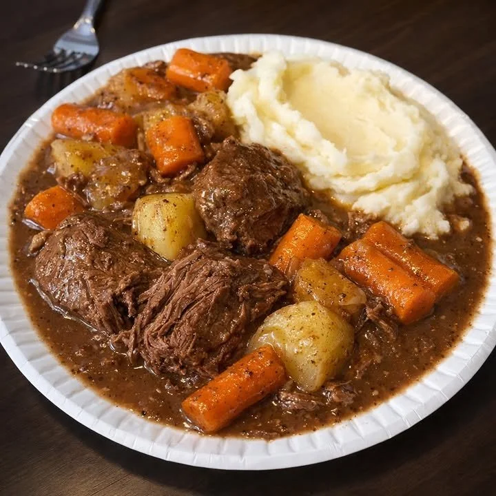 Delicious beef pot roast with potatoes and carrots served with mashed potatoes.