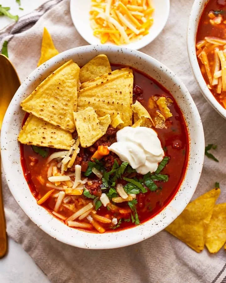 Delicious Beef Tortilla Soup garnished with tortilla strips and fresh herbs