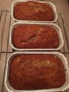 Delicious loaf of freshly baked banana bread on a wooden table