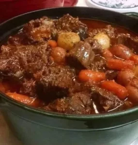 A delicious bowl of best ever beef stew with vegetables and herbs.