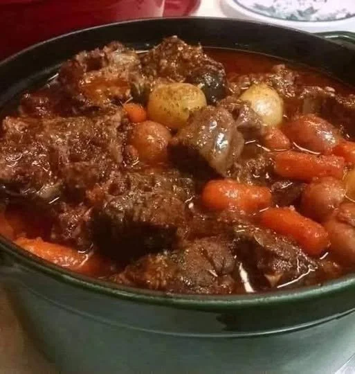 A delicious bowl of best ever beef stew with vegetables and herbs.