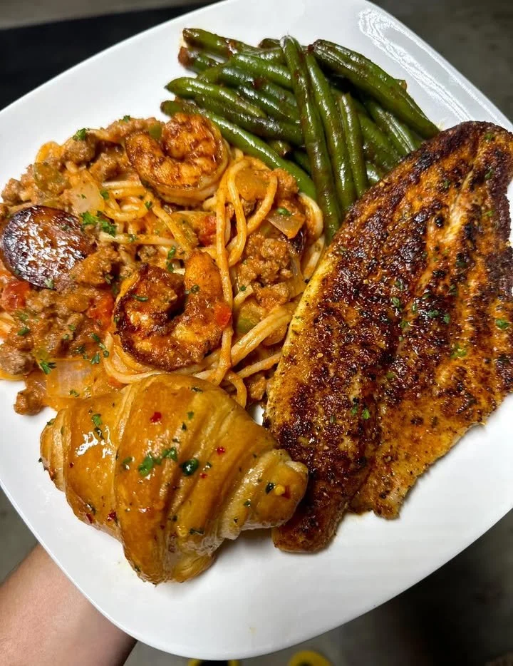 Blackened catfish served with Cajun spaghetti, a flavorful Southern dish.