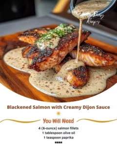 Plate of blackened salmon with creamy Dijon sauce garnished with herbs