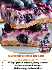 Delicious blueberry cheesecake bars topped with fresh blueberries and a graham cracker crust.