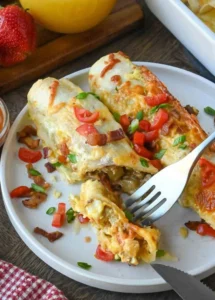 Delicious breakfast enchiladas topped with cheese and salsa.