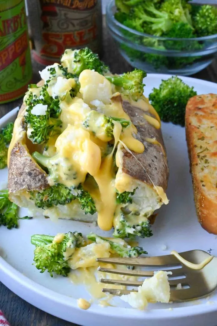 Delicious broccoli cheese baked potato topped with creamy broccoli and cheese sauce