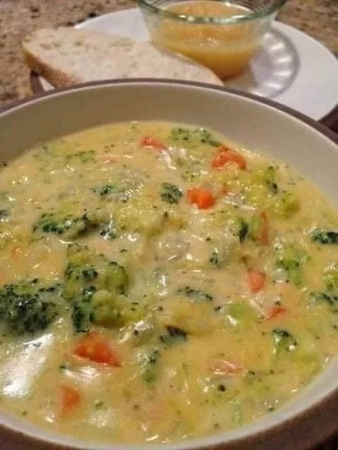 Creamy broccoli cheese soup in a slow cooker, ready to serve.