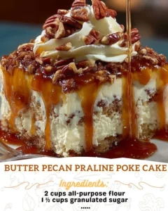 Delicious Butter Pecan Praline Poke Cake topped with pecans and praline sauce