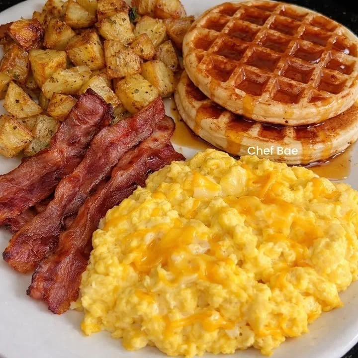 Fluffy buttermilk waffles drizzled with syrup on a plate