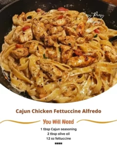 Bowl of Cajun Chicken Fettuccine Alfredo topped with herbs and spices