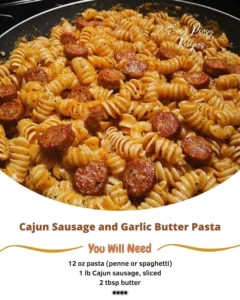 Cajun sausage pasta garnished with fresh herbs and garlic butter