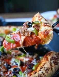 Delicious cast iron skillet pizza with a crispy crust and vibrant toppings