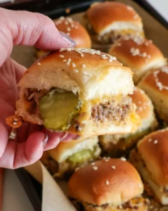 Cheeseburger sliders on Hawaiian rolls served on a platter.