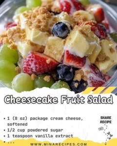 Delicious cheesecake fruit salad topped with fresh berries and creamy cheese.