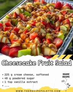 Colorful cheesecake fruit salad topped with fresh berries and whipped cream