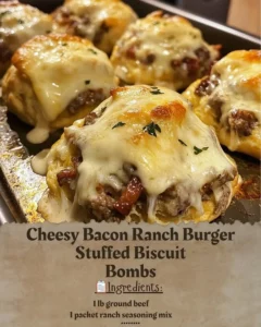 Cheesy Bacon Ranch Burger Stuffed Biscuit Bombs with melted cheese and crispy bacon