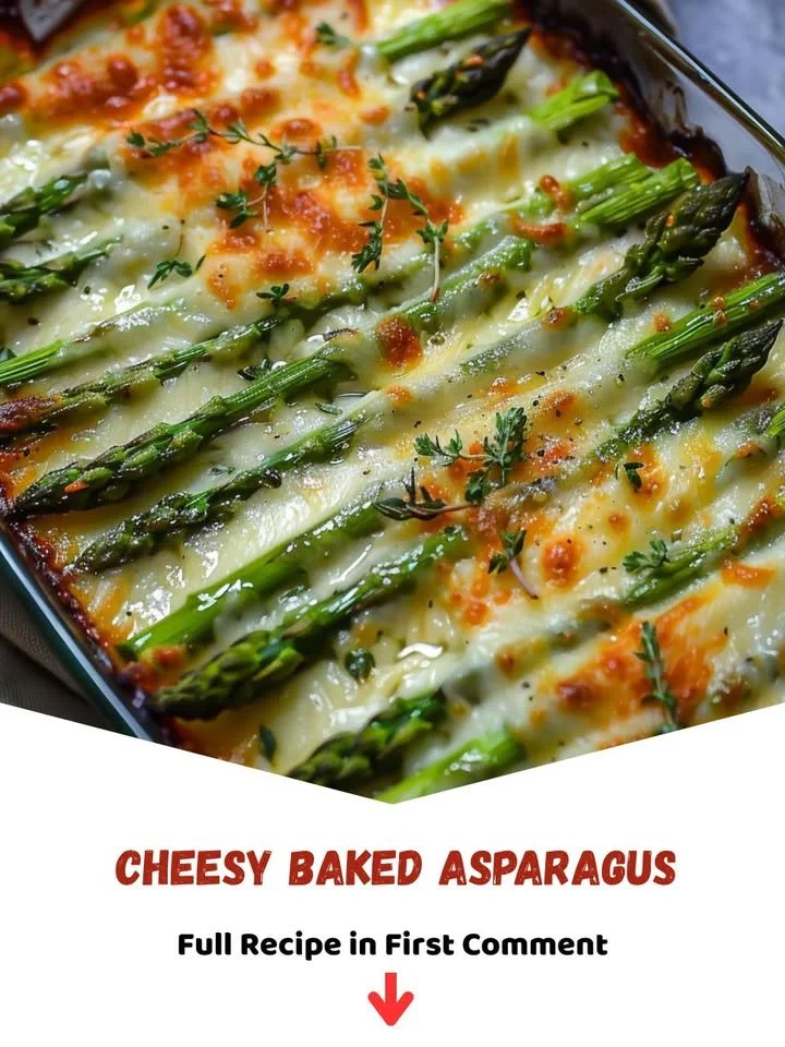 Cheesy baked asparagus dish with melted cheese and herbs on top