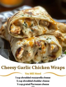 Cheesy garlic chicken wraps served on a plate with fresh herbs