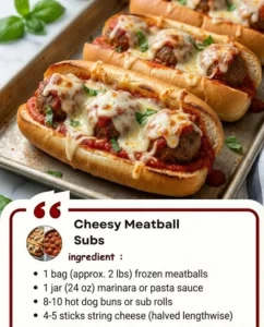 Cheesy meatball subs topped with melted cheese and fresh herbs