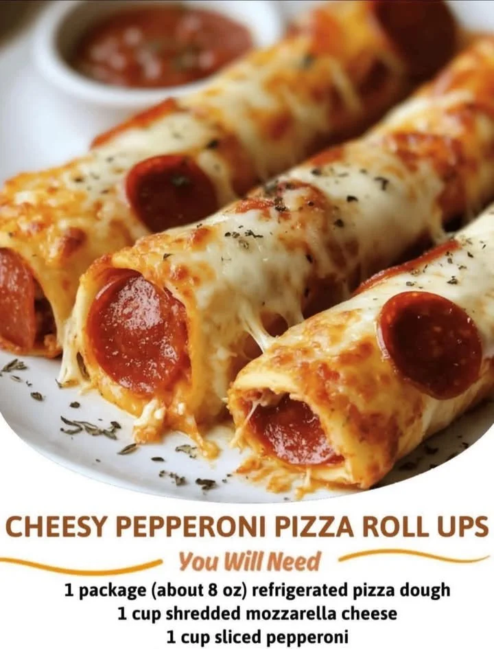 Cheesy pepperoni pizza roll-ups served on a wooden platter with herbs