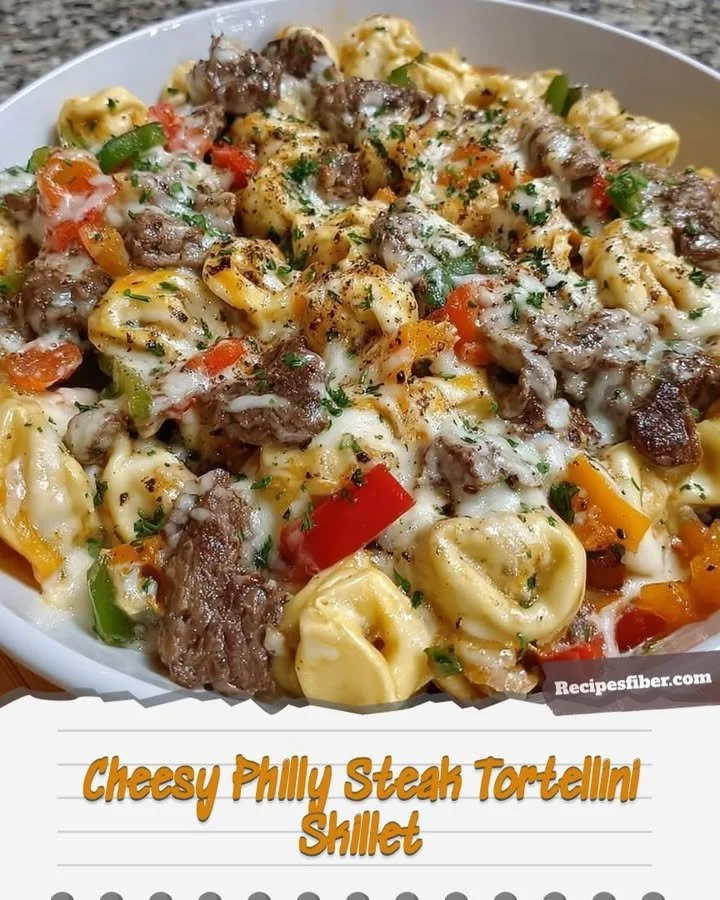 Cheesy Philly Steak Tortellini Skillet in a pan, garnished and ready to serve.