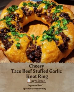 Cheesy Taco Beef Stuffed Garlic Knot Ring garnished with herbs