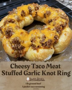 Cheesy taco meat stuffed in a garlic knot ring, a delicious party dish.