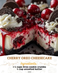 Slice of Cherry Oreo Cheesecake topped with cherries on a plate