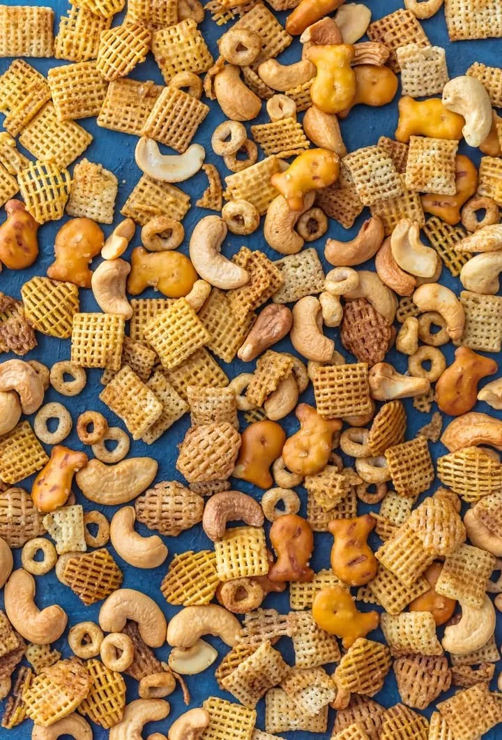 A bowl of homemade Chex Mix featuring a variety of crunchy snacks.