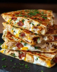 Delicious Chicken Bacon Ranch Quesadillas served on a plate with dipping sauce.