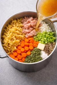 A bowl of hearty homemade chicken noodle soup with fresh vegetables.