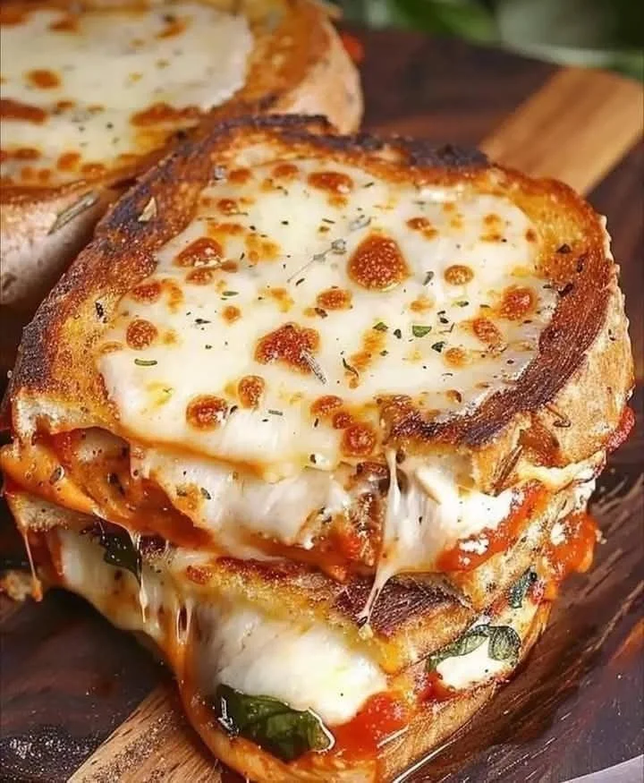 Chicken Parmesan Grilled Cheese Sandwich with melted cheese and marinara sauce