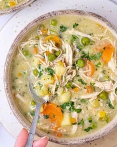 Bowl of creamy Chicken Pot Pie Soup with vegetables and chicken pieces