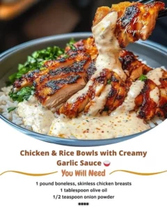Delicious Chicken Rice Bowl topped with creamy garlic sauce on a wooden table