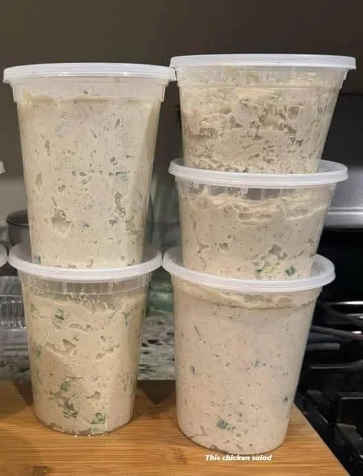 Delicious Chicken Salad in a bowl with fresh vegetables and herbs.