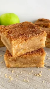 Homemade Cinnamon Apple Blondies topped with spices and apple chunks
