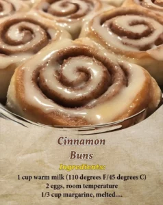 Freshly baked cinnamon buns topped with cream cheese frosting.