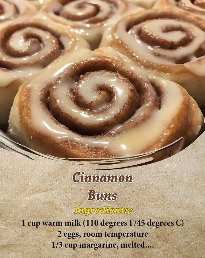 Freshly baked cinnamon buns topped with cream cheese frosting.
