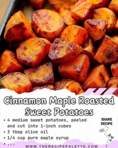 Bowl of cinnamon maple roasted sweet potatoes garnished with herbs