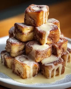 Cinnamon Roll French Toast Bites drizzled with vanilla glaze