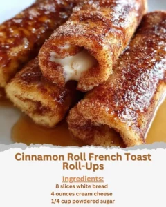Cinnamon Roll French Toast Roll-Ups served on a plate with syrup and powdered sugar