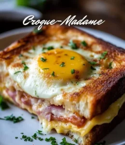 A delicious Classic Croque-Madame with cheese, ham, and a perfectly fried egg on top.