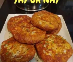 Plate of classic salmon patties served with lemon and herbs