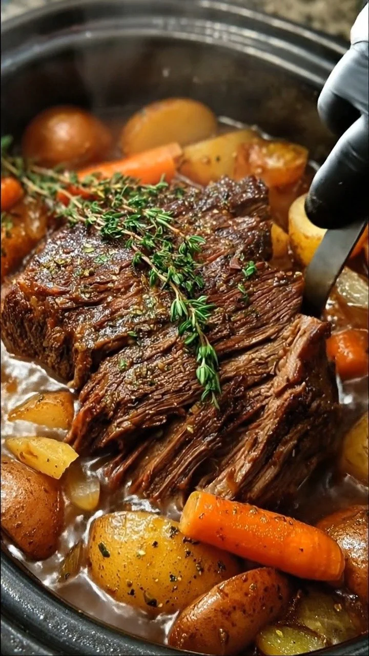 A delicious classic slow cooker pot roast served with vegetables and gravy.