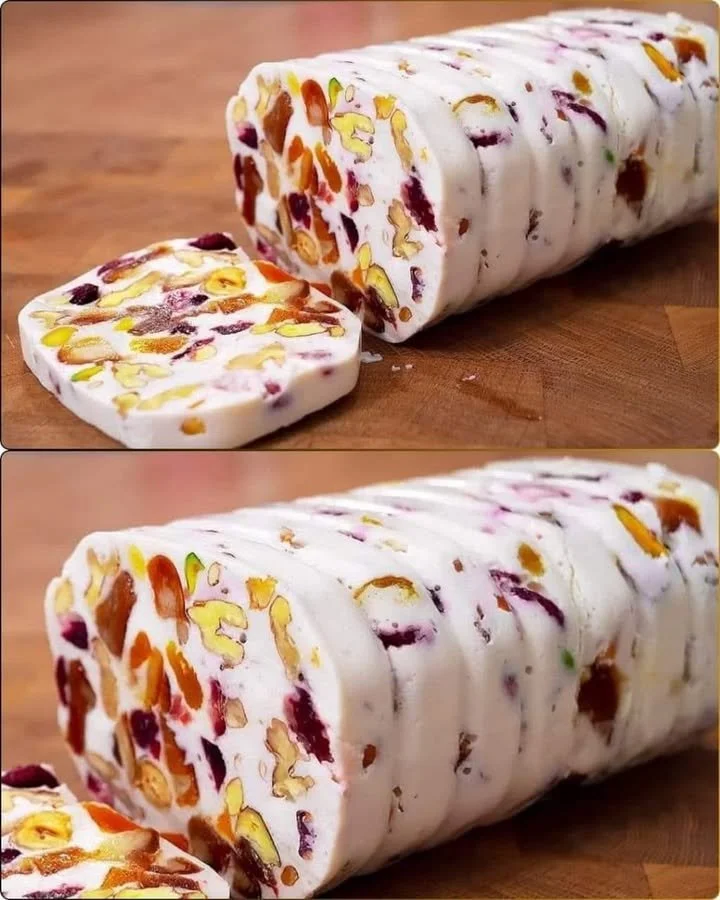 Delicious cottage cheese dessert topped with fruit and nuts in a bowl.