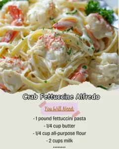 Delicious Crab Fettuccine Alfredo garnished with parsley and lemon.