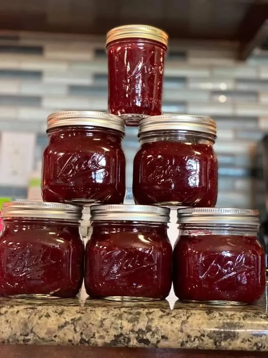 Jar of homemade Cranberry Orange Jam with fresh cranberries and oranges