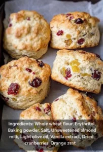 Golden brown cranberry orange scones on a rustic wooden table.